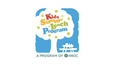 Logo for the Kids Summer Lunch Program. Logo is of a tree with a picnic bench next to it. Text in the logo reads, Kids Summer Lunch Program, A Program of HRDC.