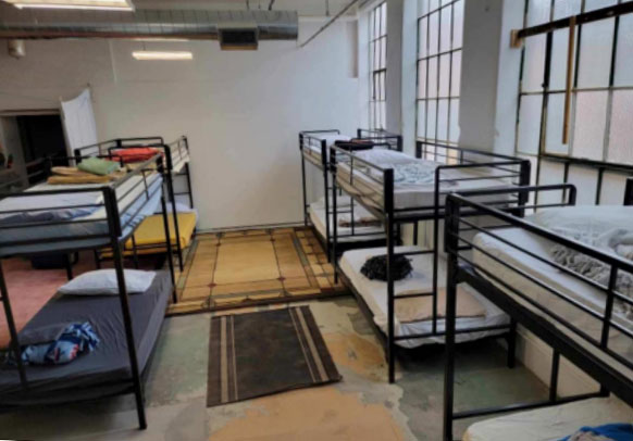 Photo of multiple bunk beds inside of the HRDC warming center. 